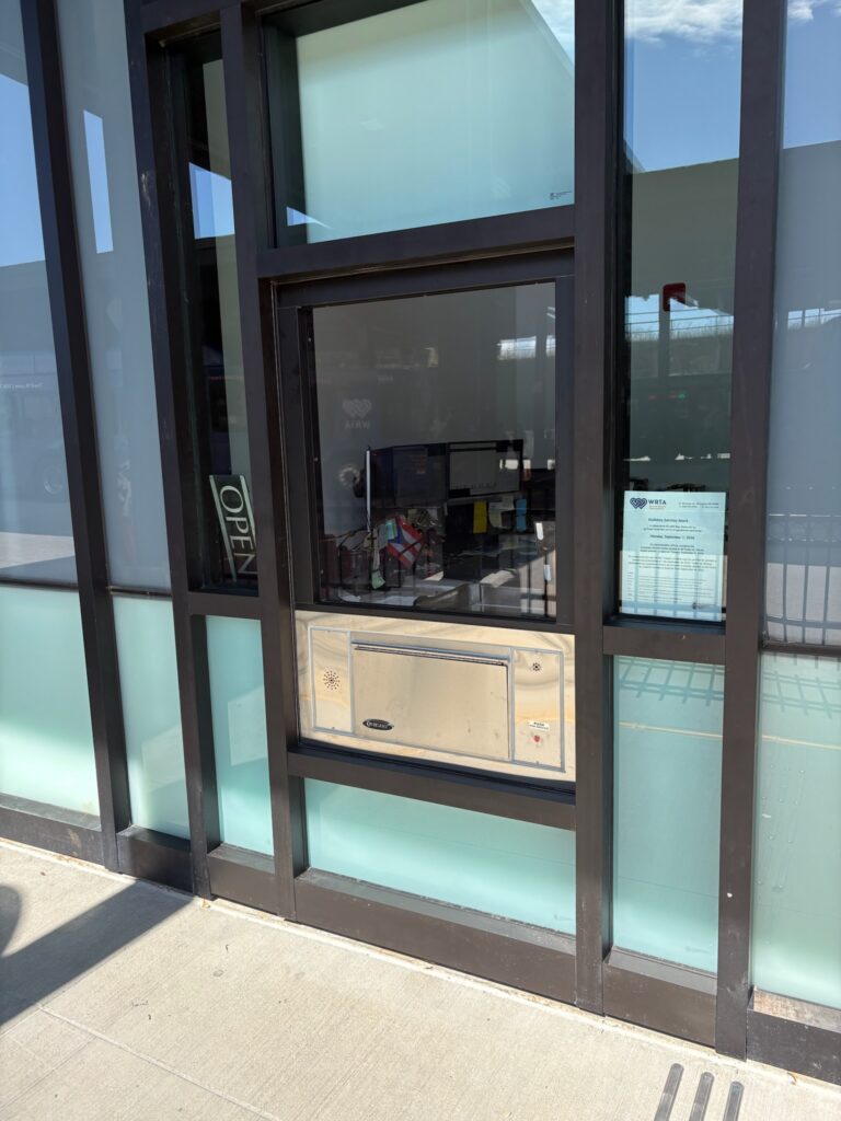 Photo shows a exterior view of the customer service window.